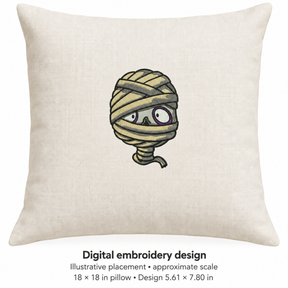Illustrative placement of Wrapped Mummy Face Embroidery Design, design 5.61 × 7.80 in on an 18 × 18 in pillow; approximate scale.